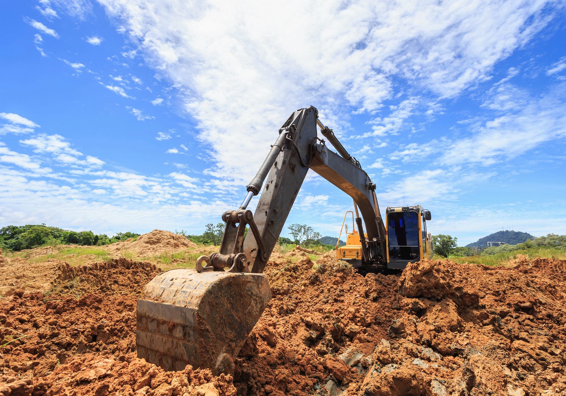 Excavator working in cut